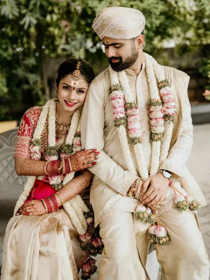 A beautiful portrait of the couple seated together after their wedding ceremony.