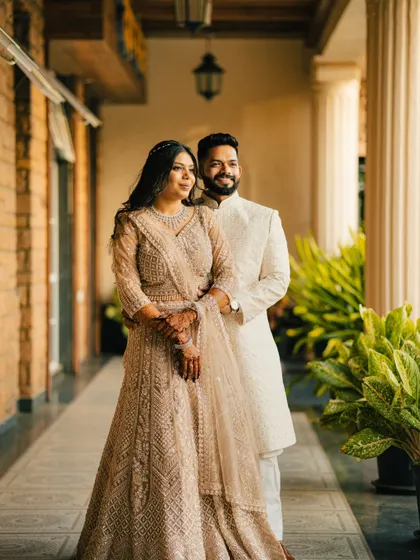 A classic portrait of a couple standing together, looking out towards the light. This image is elegant, poised, and beautifully composed.