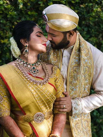 The eternal combination of a red lip and a gold saree. This bride looks absolutely timeless with her classic makeup and traditional attire.