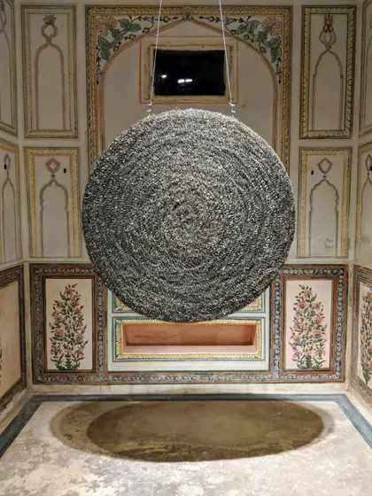 This circular sculpture, installed at Jaigarh Fort, represents the cyclical nature of existence. Made from countless cigarette butts, it hangs in a historic space, creating a dialogue between contemporary waste and timeless architecture.