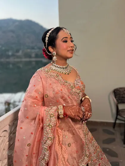 Varija looking serene and beautiful. The soft peach tones in her makeup complement her outfit and the natural surroundings perfectly.