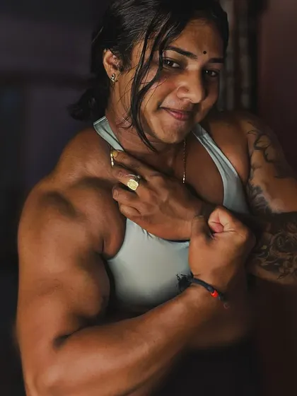 Trust your vision. A close-up bicep flex, showing the results of focused arm training. This is the 'cutest beast' in her element.