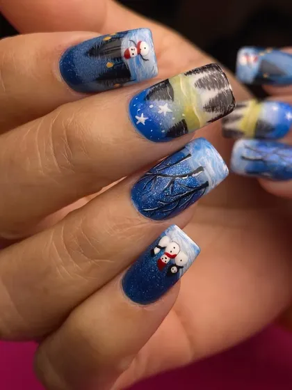 Another angle of the hand-painted Christmas landscape nails. You can see the detail in the starry night sky and the reflection of the trees in the icy water.