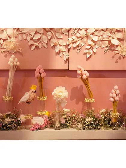 Styling our intricately carved pith wall with details like handcrafted pith birds and lotus buds. These elements help to build a cohesive and beautiful story for the dining experience.