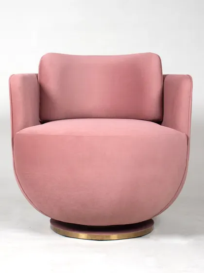 The front view of the pink swivel chair, showing its inviting curves and plush cushioning.