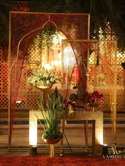 I love incorporating modern art into traditional designs. These custom thread-work arches added a contemporary touch to the entrance while maintaining the event's regal red and gold palette.