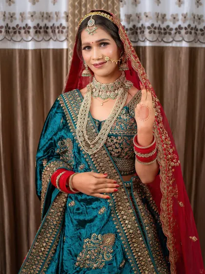 A full-length view of a student's final work: a gorgeous teal and red bridal lehenga look. This is the quality of work you'll be able to produce.
