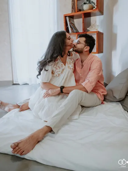 A romantic kiss shared by the couple during their intimate indoor pre-wedding session, highlighting their deep affection.