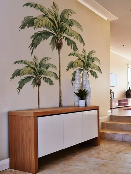 A simple console table is transformed into a stylish vignette with our Island Palm Tree stickers. They are a great way to add a decorative touch to any corner of your home.