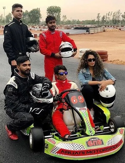 It's not just about racing; it's about the community. Here's a group of drivers posing with a kart after a session, sharing the excitement of a day well spent on the track.