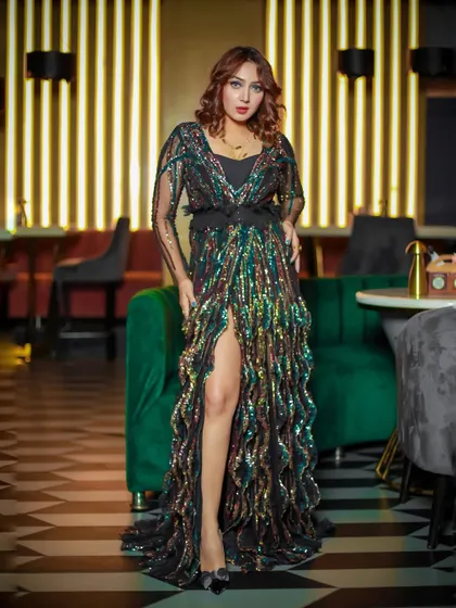 A glamorous evening wear shot of a model in a sparkling sequin gown, captured in a sophisticated lounge setting. This is the kind of high-impact shot I create for designer lookbooks and fashion portfolios.