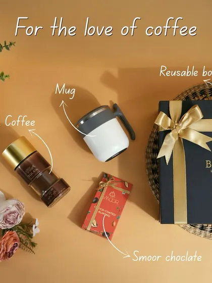 For the love of coffee. This flat-lay shows the components of a perfect coffee-themed hamper: TGL coffee, a stylish mug, and Smoor chocolate, all ready to be packed in our reusable box.