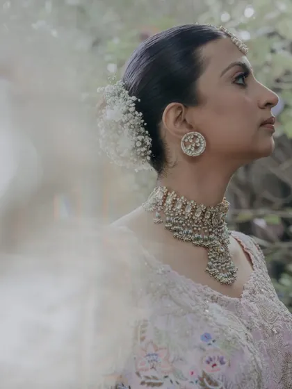 A side view of a bride with a baby's breath bun, showing its delicate texture.