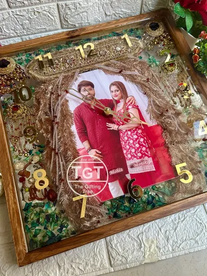 The combination of traditional wedding items, a modern photo, and a classic wooden frame makes this piece a family heirloom.