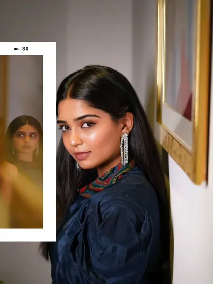 A creative shot using a mirror to capture a reflection, adding depth and a sense of introspection to the portrait.