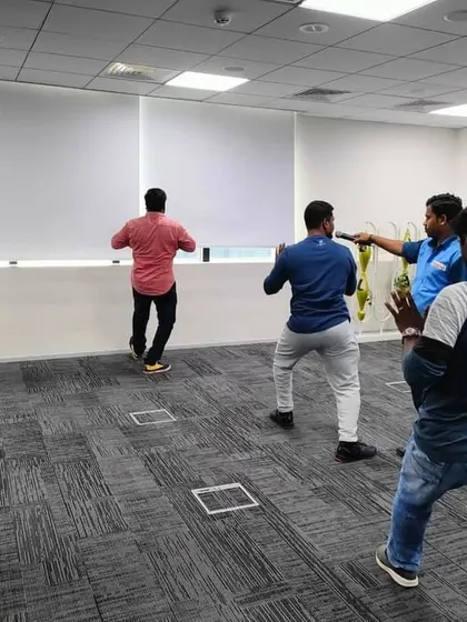 Participants in a corporate wellness seminar learning the basic stances of Tai Chi.