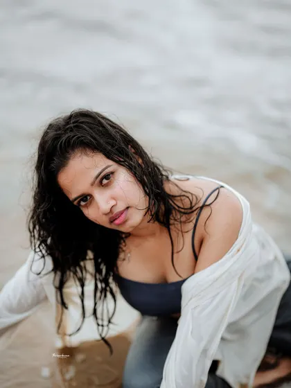 This shot captures a moment of vulnerability and strength. The water and wet look add a raw, elemental quality to the portrait.