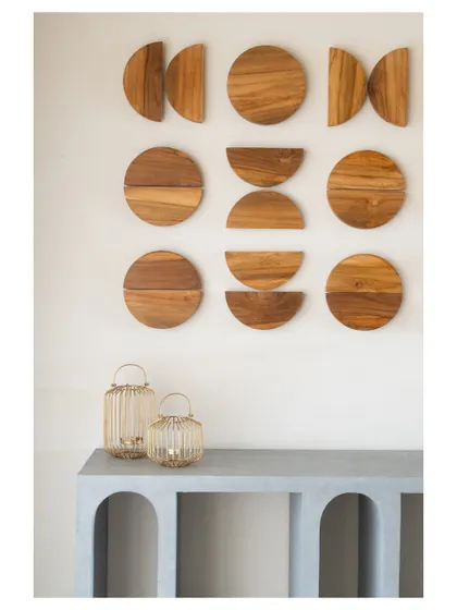 This arched concrete console table is paired with geometric wooden wall art, creating a beautiful focal point that plays with form and material.