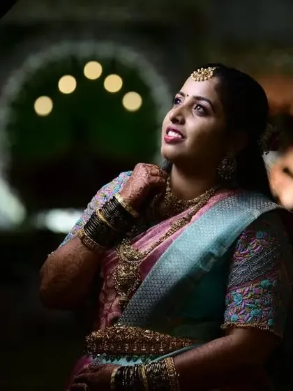 This bride looks stunning against the sparkling lights of her reception venue. Her makeup is glamorous and photo-ready, ensuring she looks her best all evening long.