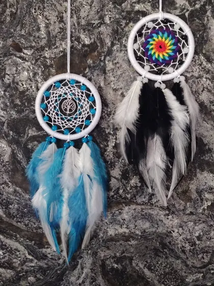 A pair of customized car hangings. One features a Tree of Life charm for grounding, while the other is a vibrant rainbow design for positivity.