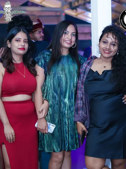 A fashionable trio of ladies enjoying their Saturday night out.