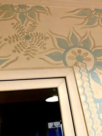 The mural design extending over the doorway. I love making the art interact with the architecture of the room, turning every corner into a part of the canvas.