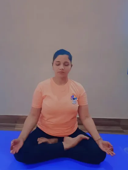 A student practices Padmasana (Lotus Pose) with Dhyana Mudra. This posture is foundational for deep meditation and pranayama, helping to manage anxiety by calming the nervous system and promoting mental clarity.