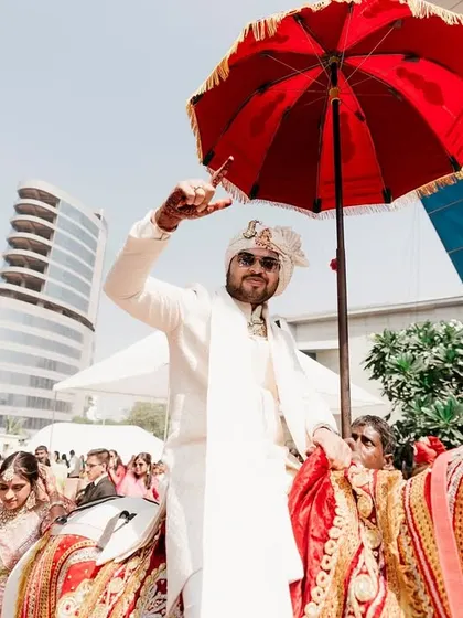 The streets come alive with the sound of joy as the baraat, led by the groom on a horse, dances its way to the wedding venue.