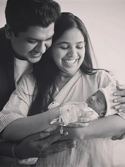 This is the kind of pure, unscripted joy I love to capture during a Fresh 48 hospital session. The happiness of new parents holding their baby for the first time is just magical. This black and white photograph focuses on the emotion and connection in this beautiful family moment.