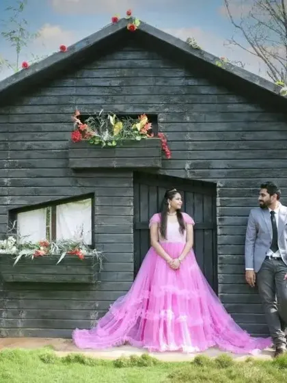 A fairytale pre-wedding shot in front of a rustic tiny house. The long trail of the pink gown adds a touch of magic.