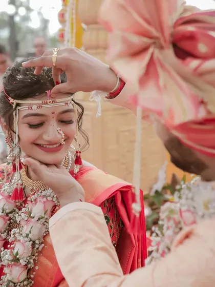 A close-up of the 'sindoor-daan' ritual in a Maharashtrian wedding. Capturing the bride's blissful smile is what makes this shot so special for us.