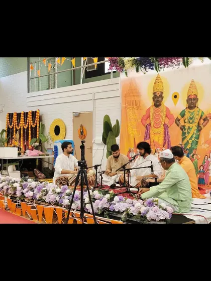 A wide shot of our performance for the Shree Vitthal Rukmini Temple Trust in the UK. The stage was beautifully decorated with images of the deities.