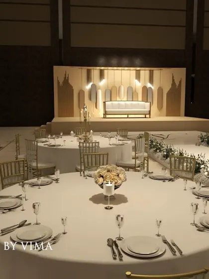 A classic and elegant reception setup symbolizing everlasting love. The stage features a modern, minimalist backdrop with custom monograms, floral arrangements, and soft lighting.