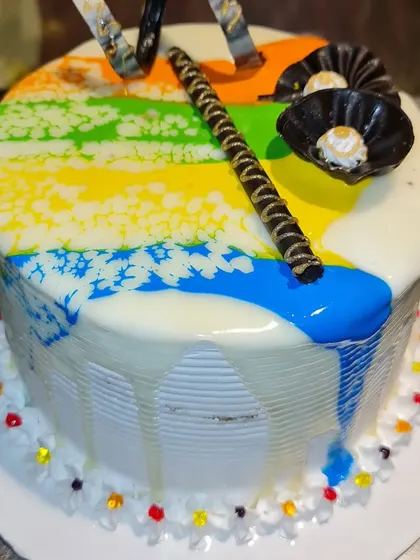 A special cake to celebrate Holi. This design features a colorful glaze that mimics the festival of colors, with a white chocolate drip.