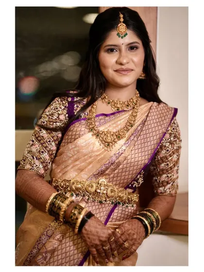 Deepika looking absolutely regal in her gold and purple Kanjivaram saree with a heavily worked blouse.