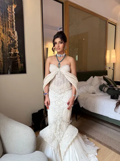 A full view of a bride ready for her reception. The sophisticated, high-volume updo I created balances the drama of her mermaid gown and ensures she looks regal throughout the evening.