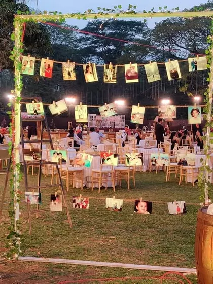 A wonderful way to share your love story with guests. We created this photo display using rustic barrels and string, where the couple could hang pictures from their journey together.