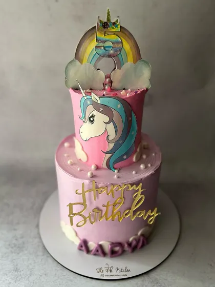 This two-tiered unicorn cake is perfect for a magical celebration, with a hand-drawn unicorn and a rainbow on top.