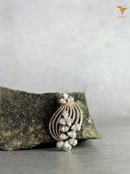 Diamonds shaped like petals, curves shaped with intention. This versatile diamond brooch or pendant is crafted to sit beautifully, wherever you choose to wear it.