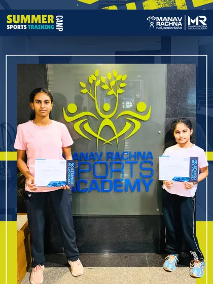 Two participants proudly display their certificates of completion at the end of the Summer Sports Training Camp. We celebrate the hard work and progress of every student who joins our program.
