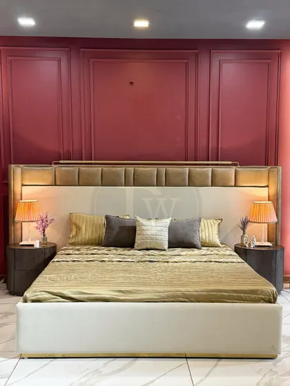 We love playing with color and texture. This bed features a two-tone upholstered headboard set against a bold, paneled wall. The design is both grand and inviting, creating a truly royal feel.