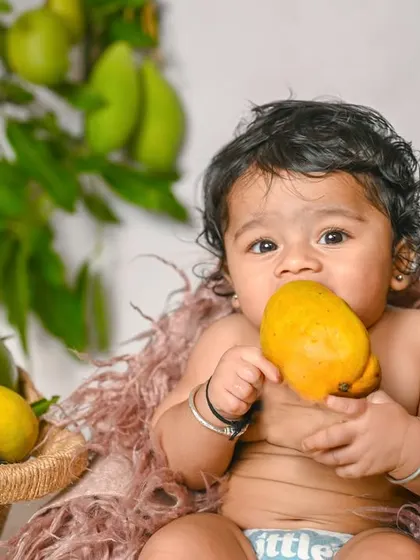 This little one is enjoying a mango during our seasonal fruit-themed shoot.