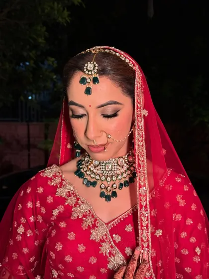 Kritika, looking stunning for her pheras. The soft glam eye makeup and flawless airbrush base complement her traditional red attire perfectly.