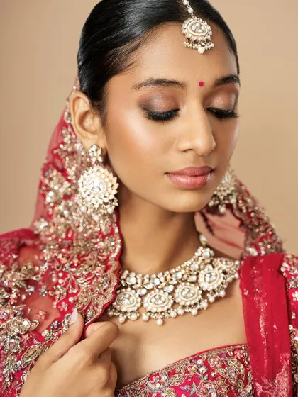A close-up of the soft smokey eye and glowing skin from Diya's bridal creation. The balance between a defined eye and a natural lip is key.