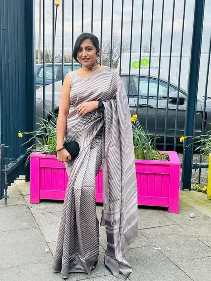 The full view of the elegant silver striped saree and its modern, custom-designed blouse.