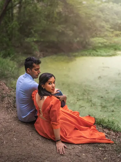A duplicate of ID 25, this outdoor shot features a couple by a mossy green pond. The woman's glance back at the camera adds a touch of storytelling to the romantic scene.