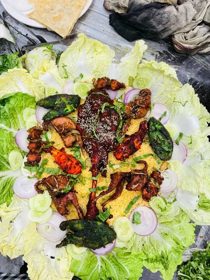 Another one of our grand platters, showcasing a variety of chicken and mutton starters on a bed of rice, ready to be served at a wedding feast.