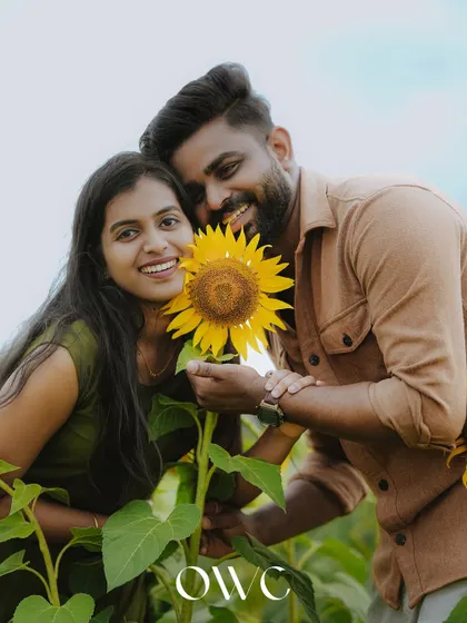 A sweet couple portrait with a sunflower, symbolizing the brightness and happiness of their relationship.