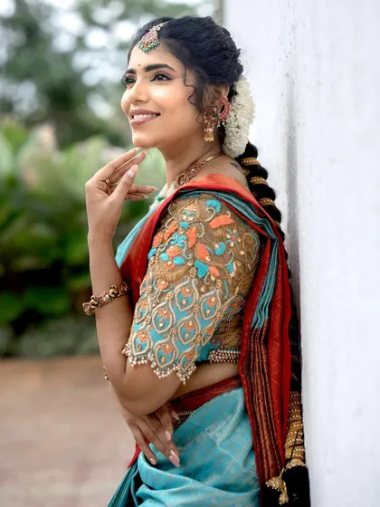 A side profile showcasing the intricate hairstyle and the beautiful details of the embroidered blouse.