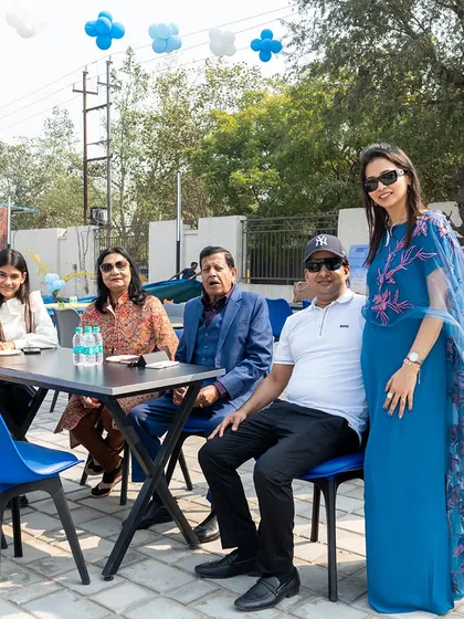 Family and friends relaxing at the outdoor seating area during a large-scale Frozen and Football themed event.